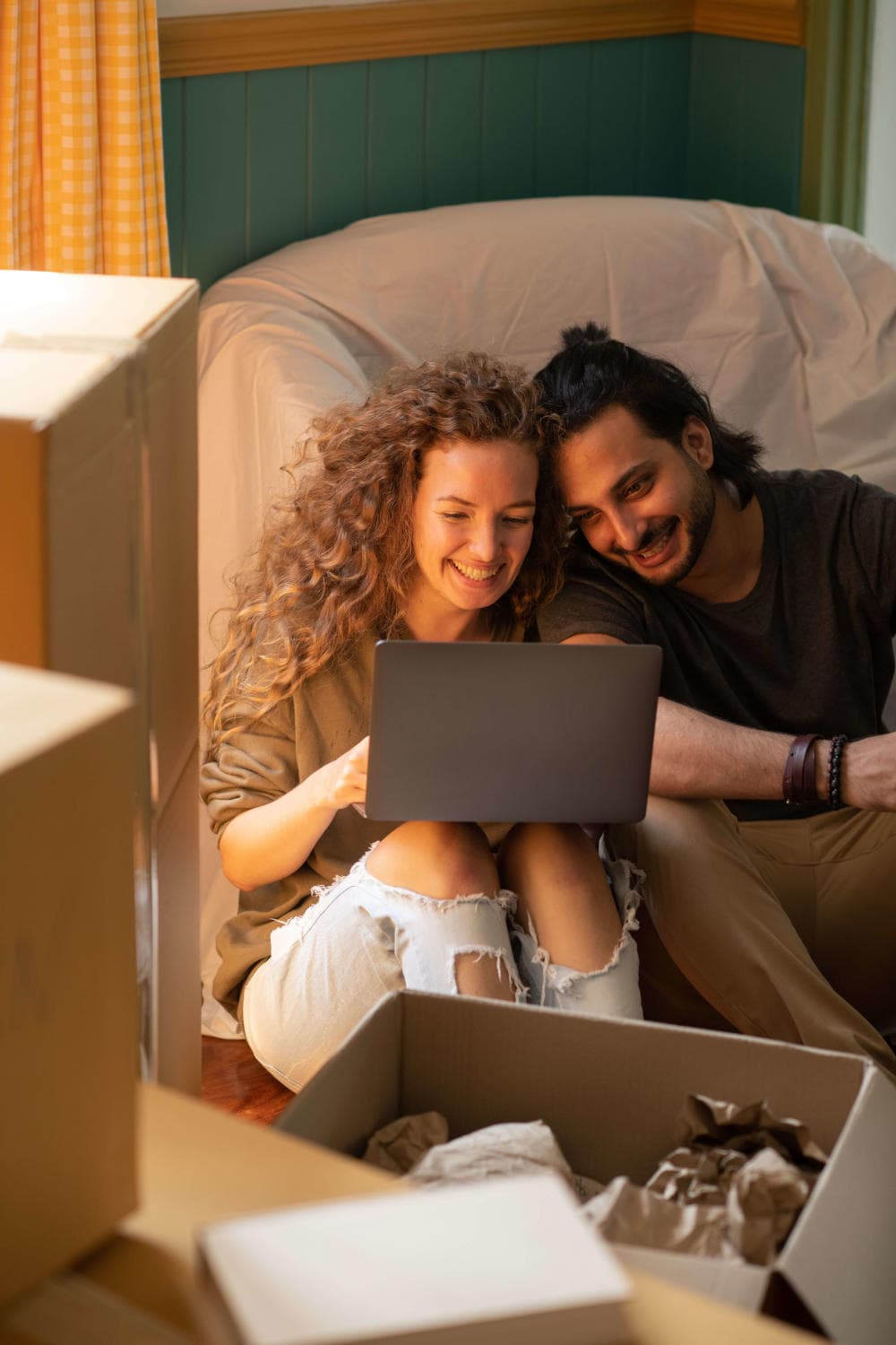 Homeowners comparing mortgage options together on a laptop
